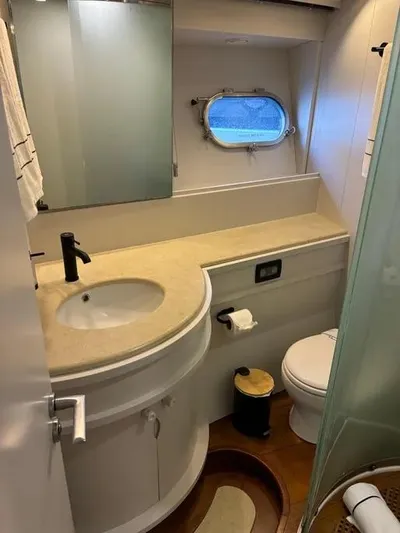  Yacht Photos Pics Luxurious bathroom in 2005 Baia Atlantica 78 yacht with modern fixtures and porthole window.