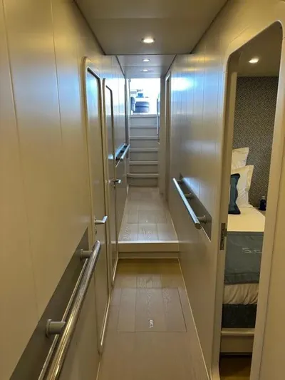  Yacht Photos Pics Narrow hallway inside 2005 Baia Atlantica 78 yacht, featuring modern design and cozy cabin entrance.