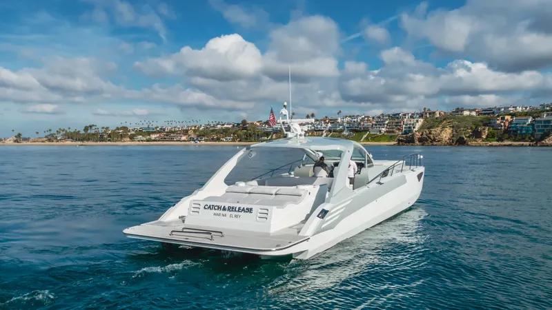 Catch And Release Yacht Photos Pics Luxurious 2017 Triton Custom yacht cruising near scenic coastline under blue skies.