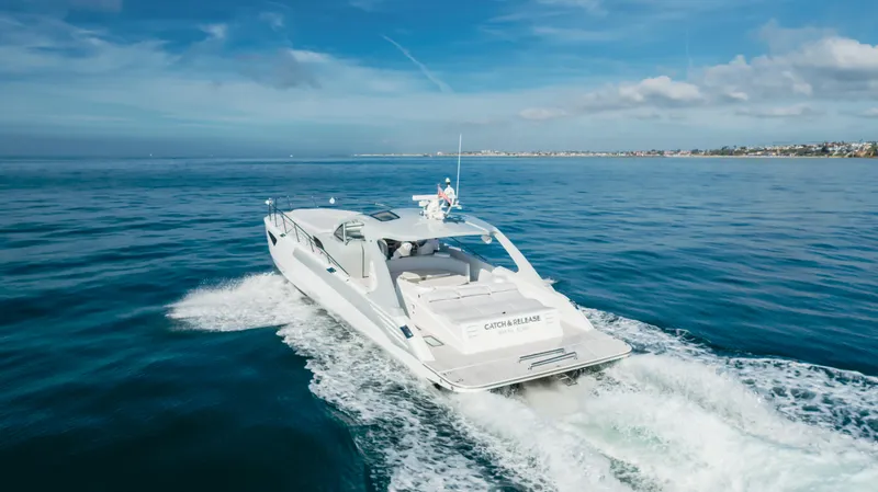 Catch And Release Yacht Photos Pics Luxurious 2017 Triton Custom yacht cruising on open sea under clear blue sky.