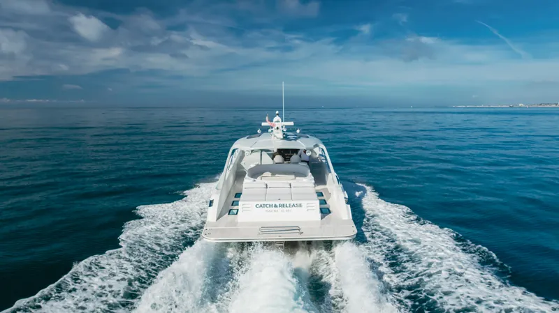 Catch And Release Yacht Photos Pics Triton Custom 2017 yacht cruising on open sea under clear blue sky.