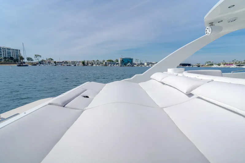 Catch And Release Yacht Photos Pics Luxurious 2017 Triton Custom boat with spacious deck, overlooking serene waterfront and cityscape.