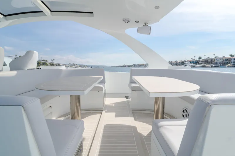 Catch And Release Yacht Photos Pics Luxurious 2017 Triton Custom yacht interior with sleek seating and tables, overlooking serene waters.