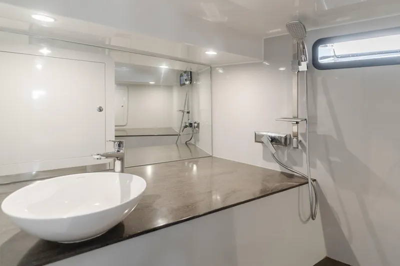 Catch And Release Yacht Photos Pics Modern bathroom with sleek design, featuring a vessel sink and wall-mounted shower in a Triton Custom 2017.