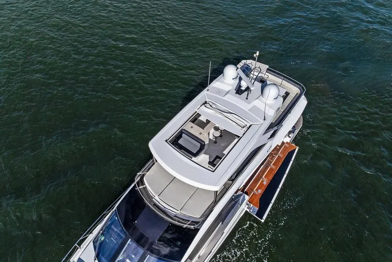  Yacht Photos Pics Aerial view of 2018 Galeon 640 Fly yacht cruising on open water.