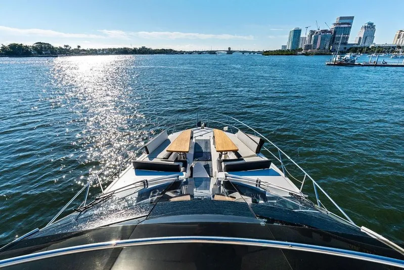  Yacht Photos Pics Luxurious 2018 Galeon 640 Fly yacht cruising on a sunny day with city skyline view.