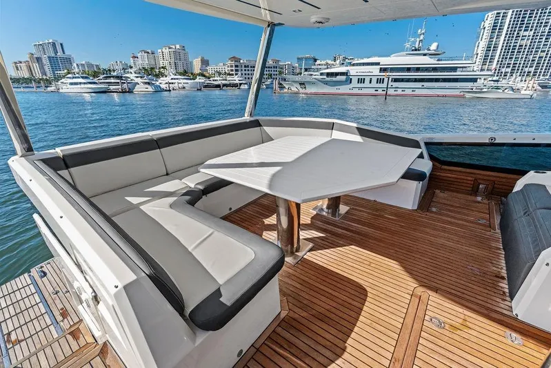  Yacht Photos Pics Luxurious 2018 Galeon 640 Fly yacht deck with seating, overlooking marina and cityscape.