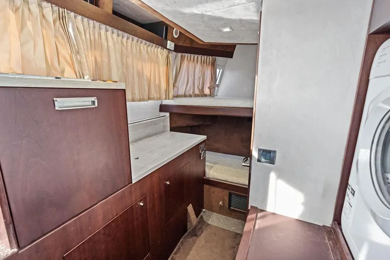 Yacht Photos Pics Interior of 2018 Galeon 640 Fly yacht with wood cabinetry and compact sleeping area.