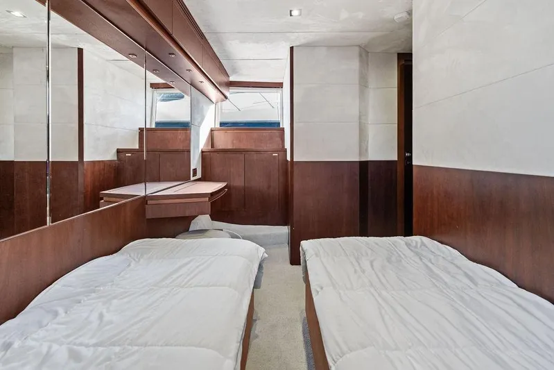  Yacht Photos Pics Luxurious cabin interior of 2018 Galeon 640 Fly yacht with twin beds and wooden accents.