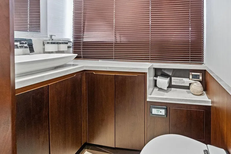  Yacht Photos Pics Luxurious bathroom interior of 2018 Galeon 640 Fly yacht with wooden cabinets and modern fixtures.
