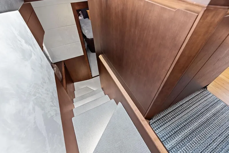  Yacht Photos Pics Staircase inside 2018 Galeon 640 Fly yacht with wooden paneling and carpeted steps.