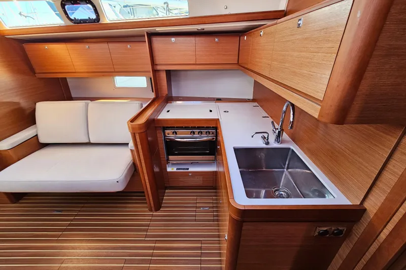 Send Me Yacht Photos Pics Luxurious 2018 Dufour 460 Grand Large yacht interior with modern kitchen and seating area.