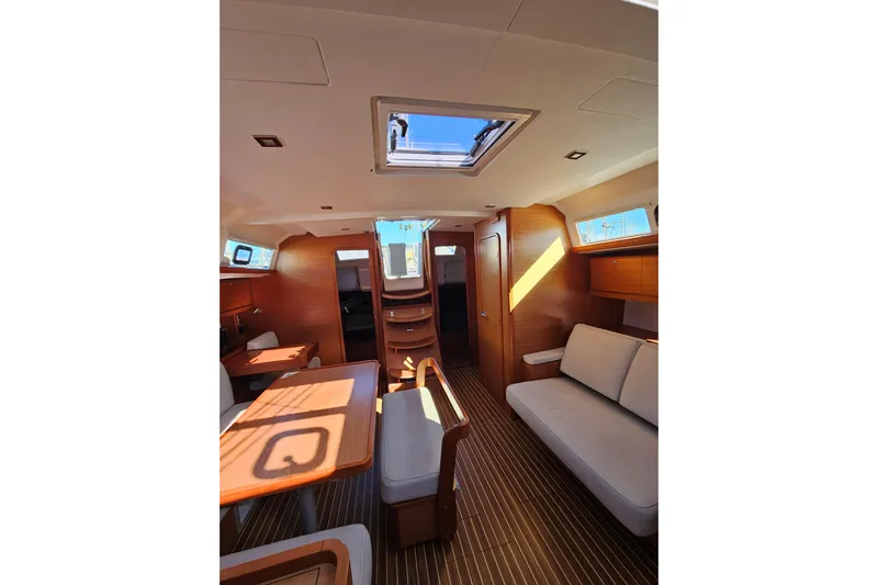 Send Me Yacht Photos Pics Interior of 2018 Dufour 460 Grand Large yacht, featuring elegant wood finishes and modern design.