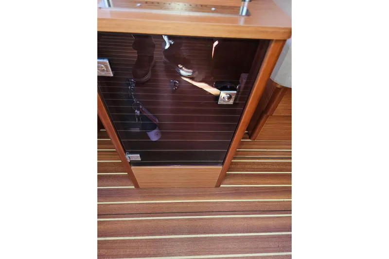 Send Me Yacht Photos Pics Wooden interior of 2018 Dufour 460 Grand Large yacht with glass cabinet door.