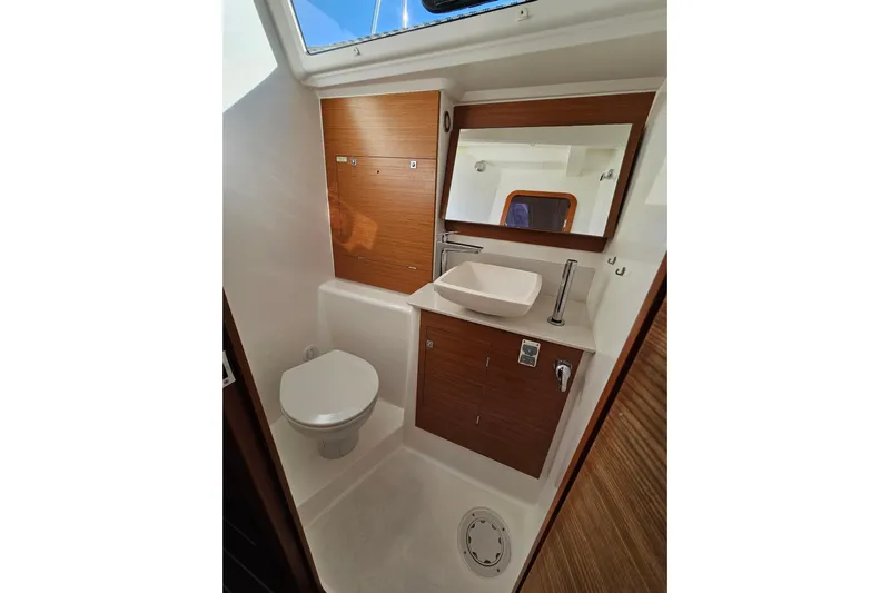 Send Me Yacht Photos Pics 2018 Dufour 460 Grand Large yacht bathroom with modern fixtures and wooden cabinetry.