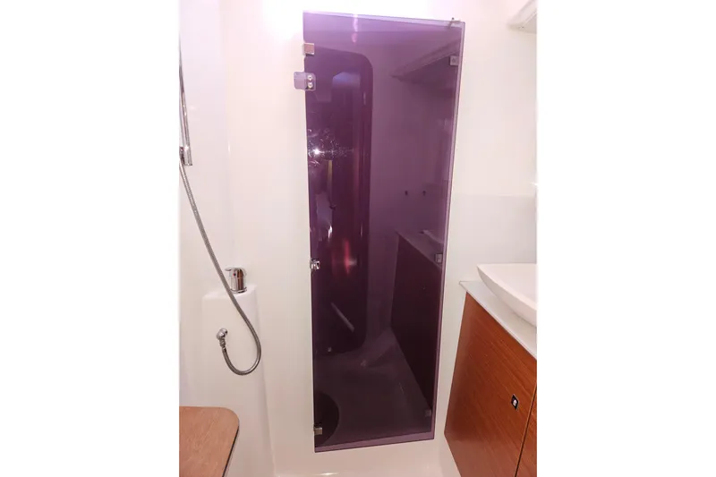 Send Me Yacht Photos Pics 2018 Dufour 460 Grand Large yacht bathroom with purple glass shower door.