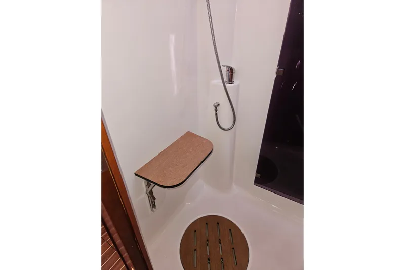 Send Me Yacht Photos Pics Shower area in 2018 Dufour 460 Grand Large yacht with foldable seat and handheld showerhead.