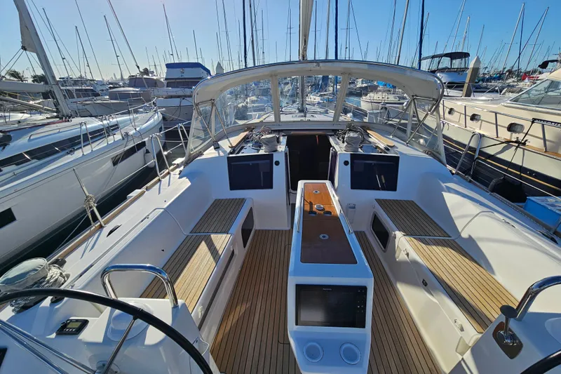 Send Me Yacht Photos Pics 2018 Dufour 460 Grand Large yacht cockpit with wooden seating and navigation equipment.