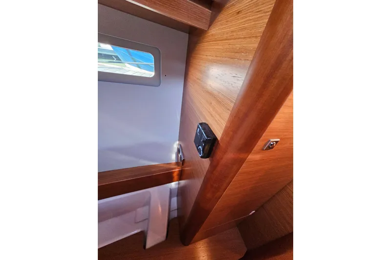 Send Me Yacht Photos Pics Interior view of 2018 Dufour 460 Grand Large yacht, featuring wooden paneling and a window.
