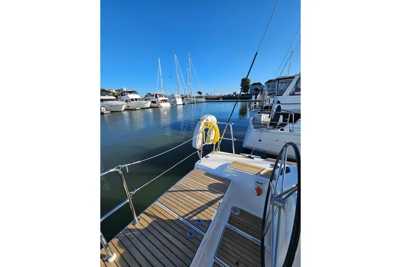 Send Me Yacht Photos Pics Dufour 460 Grand Large 2018 sailboat docked in a sunny marina.