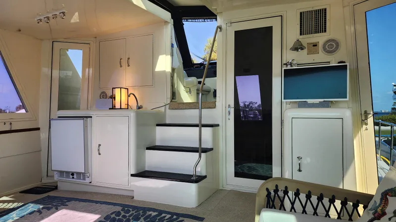 Hatt Trick Yacht Photos Pics Interior of 1990 Hatteras 52 Cockpit Motor Yacht with stairs and cabinetry.