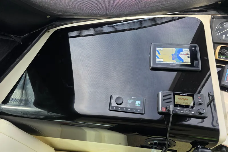 Hatt Trick Yacht Photos Pics Control panel of a 1990 Hatteras 52 Cockpit Motor Yacht with navigation equipment.