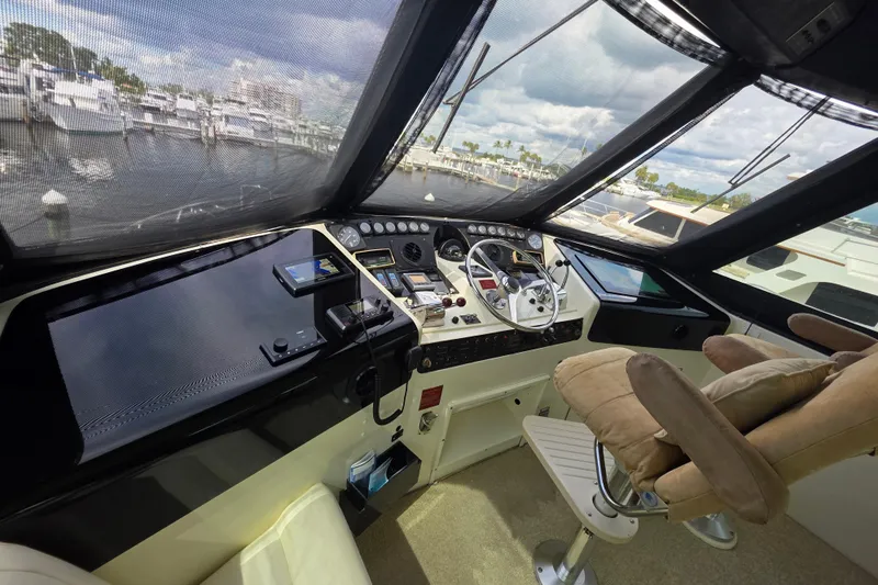 Hatt Trick Yacht Photos Pics Cockpit view of 1990 Hatteras 52 Cockpit Motor Yacht with steering wheel and controls.