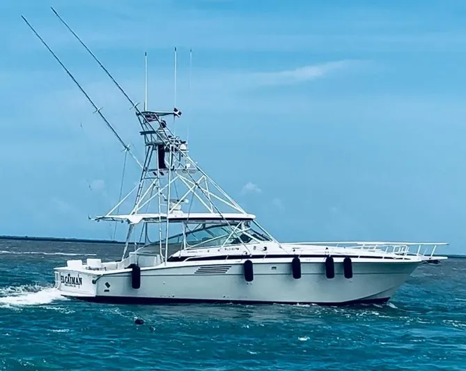 El Caiman Yacht Photos Pics 1994 Bertram 46 Moppie yacht cruising on blue ocean waters.