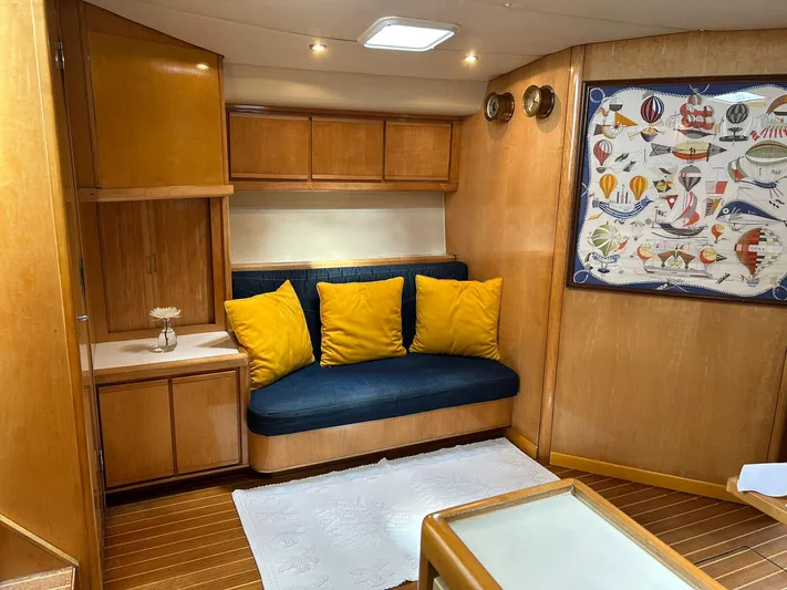 El Caiman Yacht Photos Pics Interior of 1994 Bertram 46 Moppie yacht with cozy seating and nautical decor.