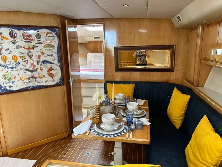 El Caiman Yacht Photos Pics Luxurious 1994 Bertram 46 Moppie yacht interior with dining area, vibrant decor, and cozy seating.