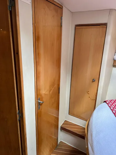 El Caiman Yacht Photos Pics Interior of 1994 Bertram 46 Moppie yacht with wooden doors and steps.