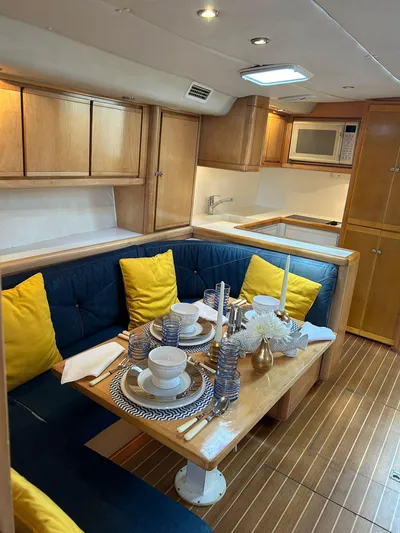 El Caiman Yacht Photos Pics Luxurious 1994 Bertram 46 Moppie yacht interior with elegant dining setup and modern kitchen amenities.