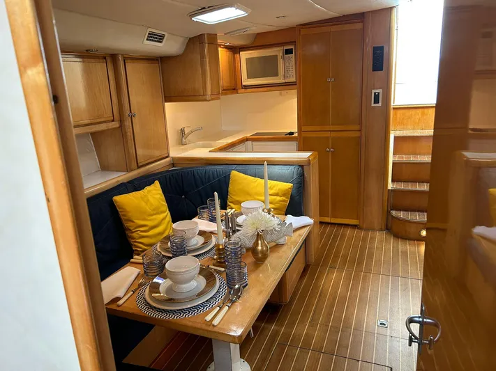 El Caiman Yacht Photos Pics Luxurious 1994 Bertram 46 Moppie yacht interior with elegant dining area and modern kitchen.
