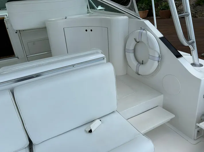 El Caiman Yacht Photos Pics 1994 Bertram 46 Moppie yacht interior with white seating and life preserver.