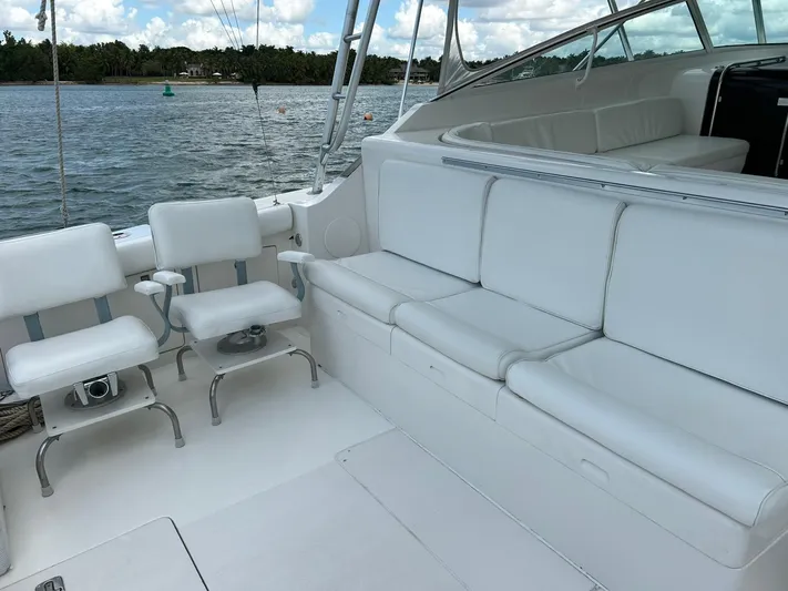 El Caiman Yacht Photos Pics 1994 Bertram 46 Moppie yacht interior with white seating, overlooking calm waters.
