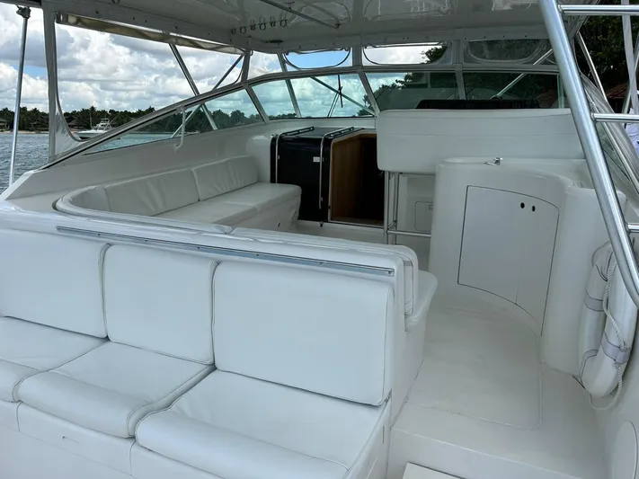 El Caiman Yacht Photos Pics 1994 Bertram 46 Moppie yacht interior with white seating and open cabin view.