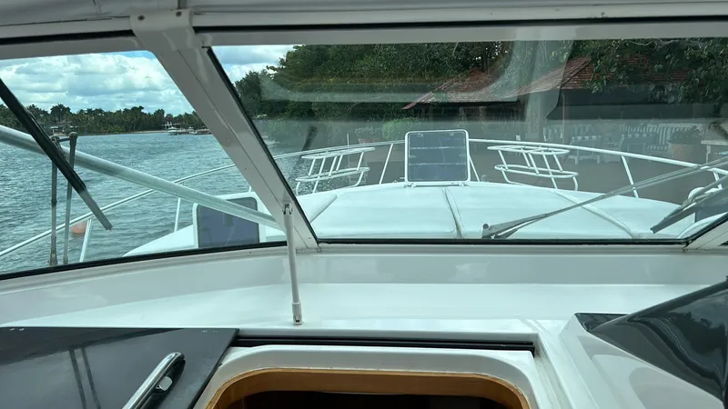 El Caiman Yacht Photos Pics View from the helm of a 1994 Bertram 46 Moppie yacht on a calm river.