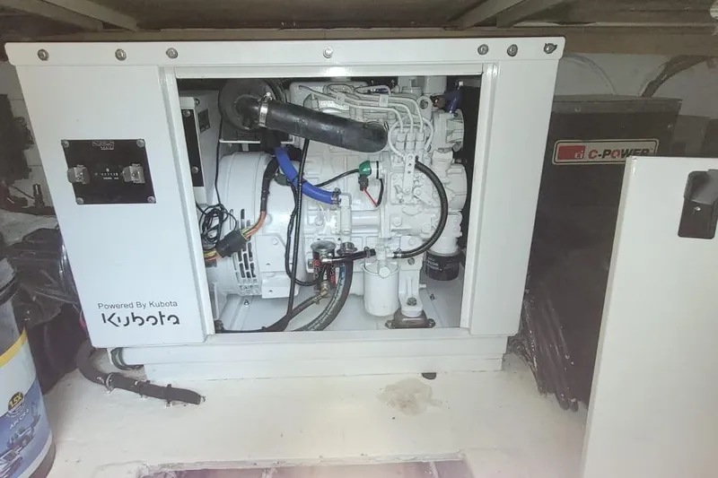 El Caiman Yacht Photos Pics Engine compartment of a 1994 Bertram 46 Moppie, featuring a Kubota-powered generator.