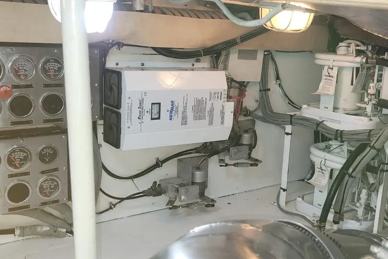 El Caiman Yacht Photos Pics Engine room of a 1994 Bertram 46 Moppie, featuring gauges and electrical equipment.