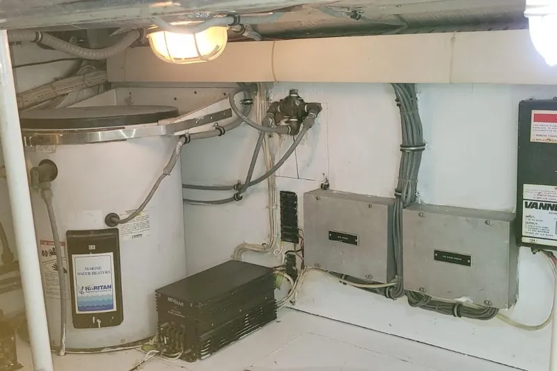 El Caiman Yacht Photos Pics Engine room of a 1994 Bertram 46 Moppie with marine water heater and electrical panels.