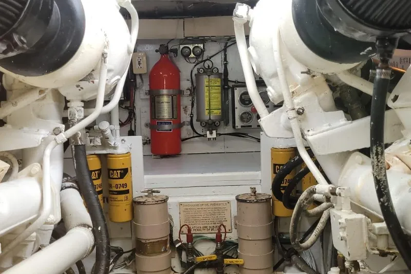 El Caiman Yacht Photos Pics Engine room of 1994 Bertram 46 Moppie with CAT filters and fire extinguisher.