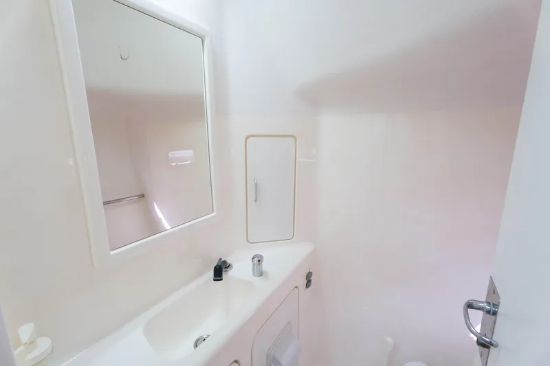 Osprey Yacht Photos Pics Compact bathroom interior of 2010 Voyage 520 yacht with sink and mirror.