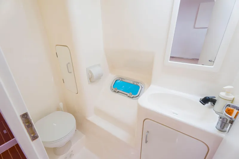 Osprey Yacht Photos Pics Compact bathroom in 2010 Voyage 520 yacht with toilet, sink, and porthole.