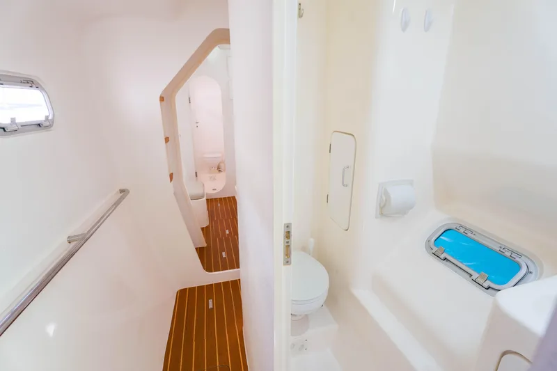 Osprey Yacht Photos Pics Spacious bathroom interior of 2010 Voyage 520 yacht with wooden flooring and porthole.