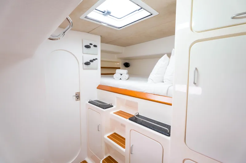 Osprey Yacht Photos Pics Luxurious cabin interior of 2010 Voyage 520 yacht with cozy bedding and modern amenities.