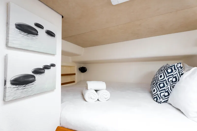 Osprey Yacht Photos Pics Cozy cabin interior of 2010 Voyage 520 yacht with decorative pillows and artwork.