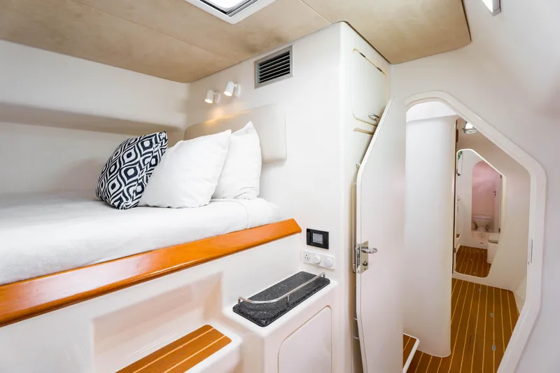 Osprey Yacht Photos Pics Cozy cabin interior of 2010 Voyage 520 yacht with bed and bathroom.