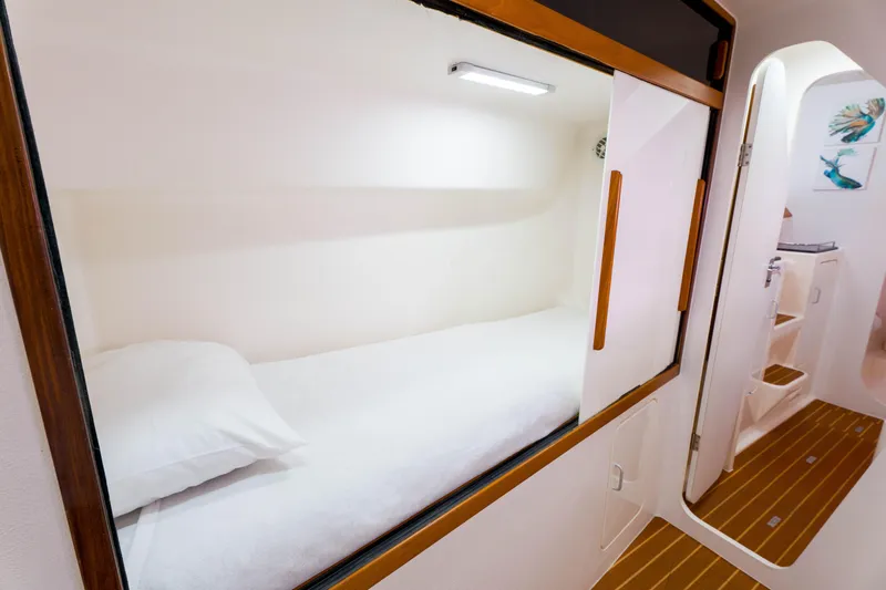Osprey Yacht Photos Pics Cozy cabin interior of 2010 Voyage 520 yacht with wooden accents and white bedding.