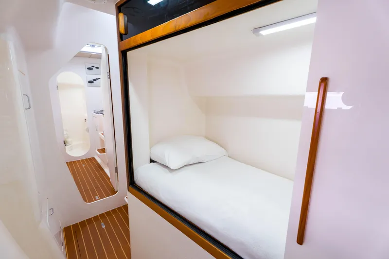 Osprey Yacht Photos Pics Compact cabin interior of 2010 Voyage 520 yacht with single bed and wooden accents.