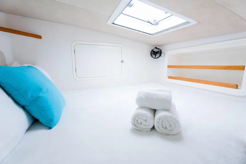 Osprey Yacht Photos Pics Cozy cabin interior of 2010 Voyage 520 yacht with rolled towels and blue pillow.